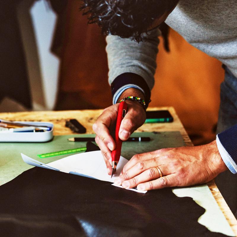 Shoemaker or shoe designer working with leather for the production of handmade shoes 1