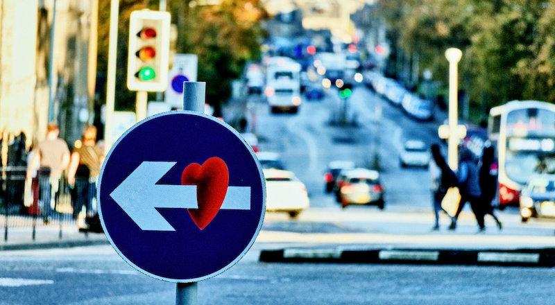 Street sign with graffiti art of heart